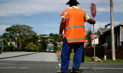 crosswalk guard orange vest stop sign