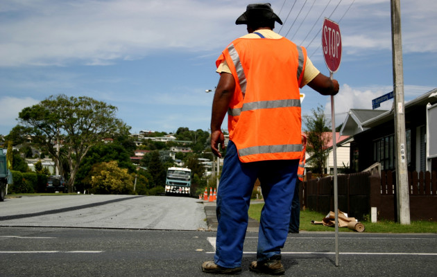 crosswalk guard orange vest stop sign